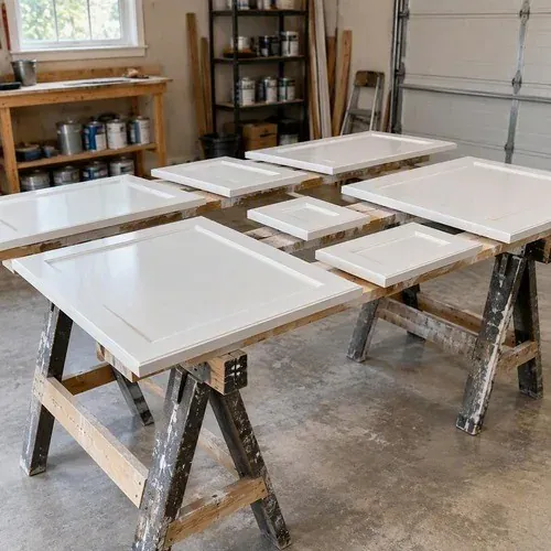 Freshly sprayed kitchen cabinet doors curing on sawhorses in the spray shop